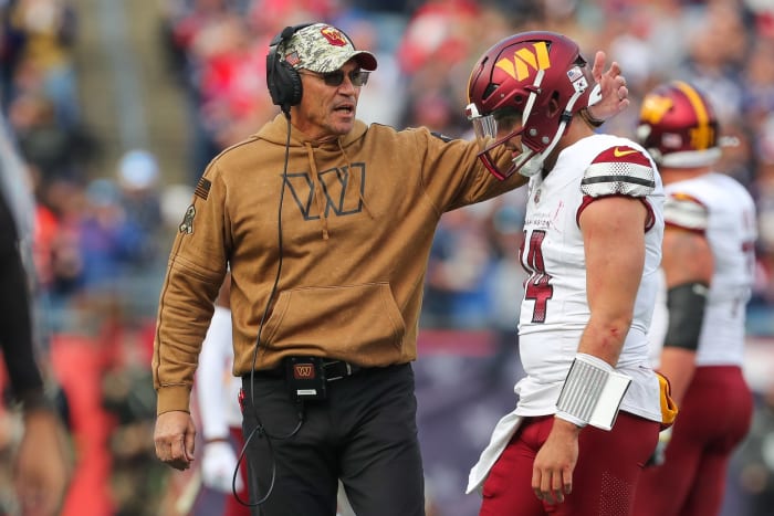 Commanders coach Ron Rivera talks to quarterback Sam Howell after Howell was intercepted during Washington's win over the Patriots in Week 9.